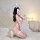 A woman poses in a pink leopard bunny girl cosplay bodysuit, featuring cute bunny ears and fishnet stockings, creating a play...