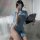 A woman poses with a smartphone and fan, wearing a blue sheer high-waist slit uniform featuring floral patterns, part of the ...
