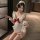 Playful maid costume featuring a sexy backless apron with ruffled trim, perfect for women seeking an elegant yet daring look.