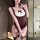 Woman modeling a burgundy and white plus size bunny costume bodysuit with ruffles, bow detail, and lace thigh-highs in a mode...