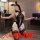 Plus size bunny girl costume with sheer back bodysuit, white ruffled skirt, lace thigh highs, and black ears for curvy women.