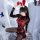 A woman poses in a dark fantasy role play outfit featuring a latex bunny girl design with red bondage elements and adjustable...