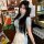 Woman wearing a plus size chinese style cheongsam lingerie set, featuring a retro maid dress with apron, embodying a busty pu...