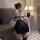 Woman wearing a black plus size chinese-inspired lingerie dress with high slit, backless design, and embroidered details in a...
