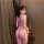 Woman wearing sheer purple mesh cheongsam lingerie with high-waist ties, back view in elegant room setting.