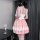 A woman wears a charming pink maid costume dress with ruffled details, featuring a sweet a-line skirt perfect for women seeki...
