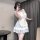 A woman poses with a smartphone, wearing a charming maid costume dress featuring a sweet girl design. the dress has a cute a-...