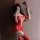Woman in red lace bodysuit with ripped sheer thigh highs, holding a heart wand, perfect for couples fun.