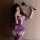 Woman in purple ripped sheer bodysuit and thigh highs holding a feather whip, perfect for couples intimate moments.