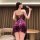 A woman stands elegantly, wearing a plus-size floral velvet bralette sleep set. the design features intricate lace sheer cami...