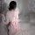 A woman sits on a bed wearing a plus-size japanese-inspired sheer kimono sleep dress. the delicate lace trim and sensual desi...