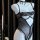 Black lace bodysuit with open crotch and wire-free push-up design, displayed on a mannequin with elegant accessories.
