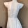 White plus size satin chemise set with lace trim and adjustable ties, shown on mannequin from back view.