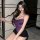 Curvy woman wearing purple lace lingerie set with thin straps and matching panties, showcasing elegant design.