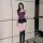 Curvy woman modeling purple lace lingerie set with thin bra and black shorts, paired with thigh-high boots.