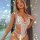 Blonde woman wearing a white plus size lace sexy bodysuit with sheer open-crotch thong and bralette, no-remove design for cur...