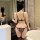 Woman wearing plus size leopard print lace bodysuit with open-crotch tie-up design, cat ears, and thigh-high stockings in bat...
