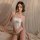 A woman poses elegantly in a luxurious white lace bodysuit, featuring an open-crotch design and delicate straps. the set exud...