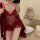 Woman wearing red lace lingerie sleep set with satin robe, perfect for date nights.