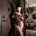 Sheer black lace bodysuit with push-up cups and open-crotch design, styled as sensual sleepwear for small busts.