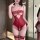 Woman wearing red plus size lingerie set with steel-boned push-up, open-crotch design, and lace trim for sexy bedtime wear.
