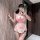 Woman modeling pink plus size maid costume lingerie set with apron, headband and wrist cuffs in mirror selfie.