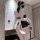Woman wearing a black and white plus size maid costume with open-crotch design, featuring lace trim and bow accents.