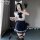 A person wearing a sailor uniform set, featuring a white crop top with blue accents, a navy pleated skirt, knee-high socks, a...
