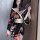 A woman elegantly poses wearing a plus-size seductive geisha lingerie set inspired by japanese kimonos. the low-neck design f...