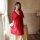 A woman models a plus-size sheer red lingerie set, featuring delicate lace details and a flowing design, perfect for sensual ...