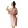 A woman holds a bouquet while wearing a sheer pink plus-size sleepwear set, featuring delicate lace details and soft fabric f...