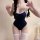 A woman poses wearing a navy blue plus-size sexy bodysuit swimwear, featuring sheer milk silk tank leotard one-piece swimsuit...
