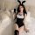 A woman poses on a bed wearing a black bunny costume with rabbit ears, featuring a maid outfit design. the set includes lace ...