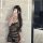 Woman in plus size sexy lace bondage outfit, sheer see-through uniform set for date night and role play, posing with phone.