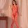 Woman modeling red lace-up fishnet bodysuit with tear-away crotch, sheer mesh lingerie in bedroom setting.