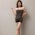 Woman wearing black plus size sexy lace fishnet bodystocking with tear-away sheer mesh design.