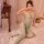 Woman wearing plus size sexy lace fishnet bodystocking with tear-away crotch, sheer mesh lingerie outfit on bed.