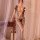 Woman wearing plus size sexy lace mesh bodystocking with sheer open-crotch fishnet design.