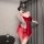 Woman wearing red sheer mesh sleep dress with open-crotch design, featuring lace trim and bow detail, perfect for role play n...