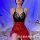 Woman wearing a plus size sexy lace sleepwear set featuring a black sheer mesh nightgown with a high slit and provocative uni...