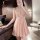 Woman wearing plus size sexy lace sleepwear, deep v thin cami nightgown in soft pink, elegant lingerie set.
