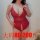 Curvy woman modeling red lace bodysuit with deep v-neck and open-crotch design, perfect for romantic bedroom moments.