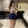 Woman in hotel room wearing plus size sexy lingerie set with uniform style top and blue skirt, featuring thigh-high stockings...