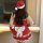Sexy red dress with santa hat, festive bow, perfect holiday outfit for women.
