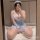 Curvy woman in plus size sexy lingerie set, sheer seductive maid costume with lace details and thigh-high stockings.