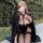 Woman wearing plus size sexy lingerie set with revealing bra and thong, styled for outdoor role play.