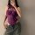 Woman wearing purple lace lingerie set with sheer bodice and matching bottoms, styled as seductive sleepwear or roleplay cost...