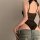 Woman wearing black lace lingerie set with jeans, showcasing seductive sleepwear and roleplay costume in qqny style.