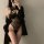 Woman wearing black lace lingerie set with sheer bodysuit and blazer, plus size seductive sleepwear for roleplay.