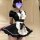 A woman models a black and white maid costume set, featuring a ruffled apron, puffed sleeves, and a flared skirt, perfect for...